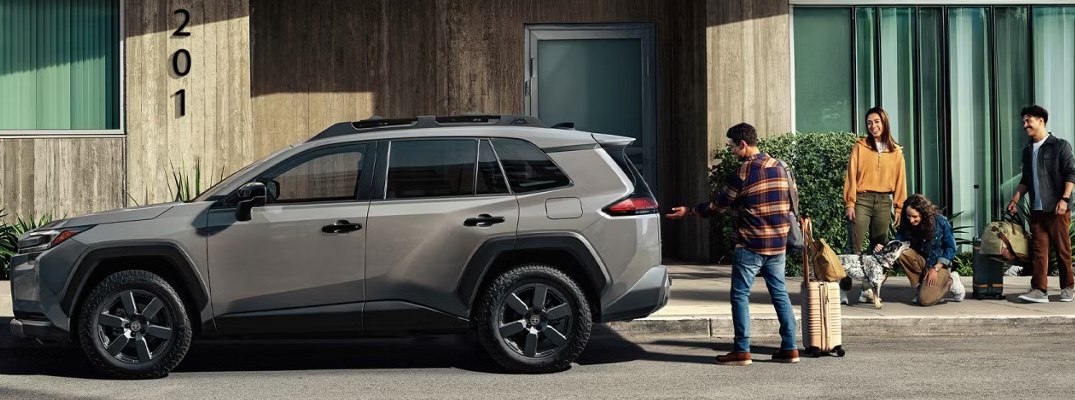 Passengers load up a 2026 Toyota RAV4.
