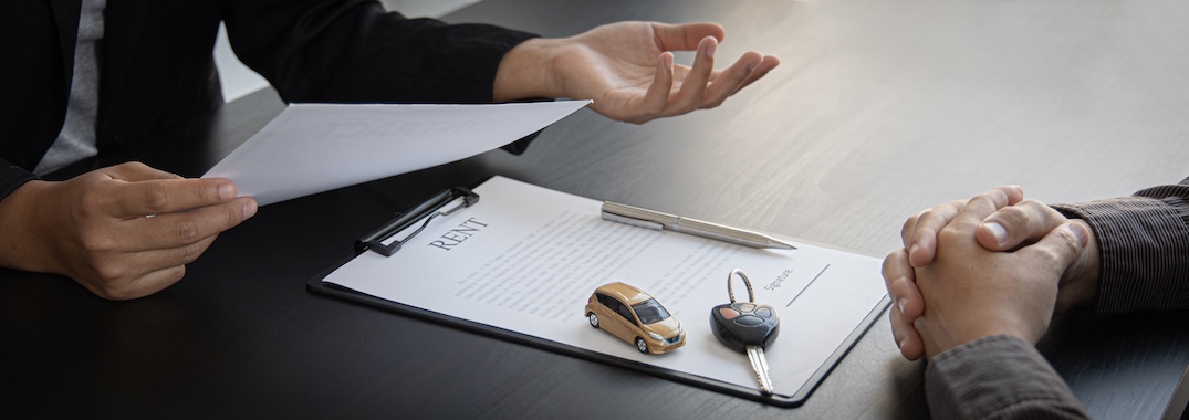 A dealer discusses a trade in offer with a car owner.